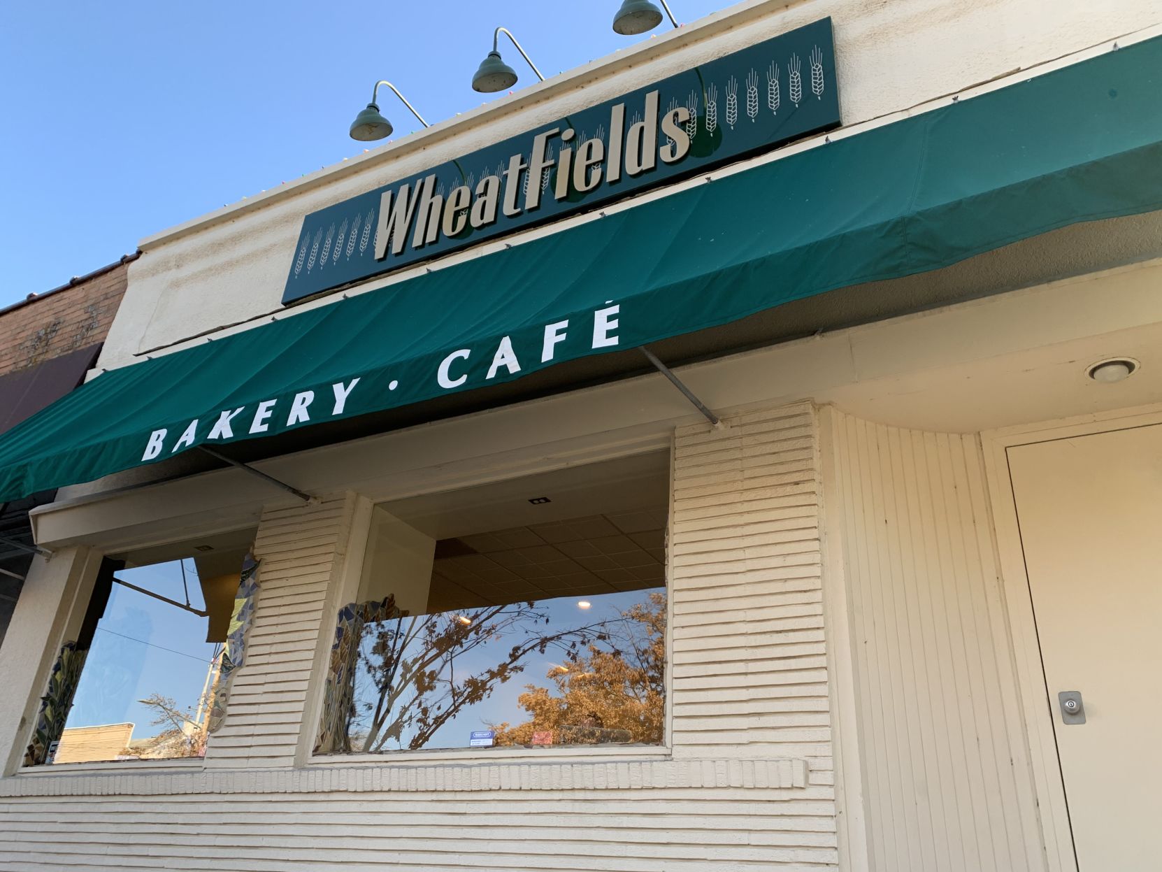 An awning over the entrance to Wheatfields Baker and Cafe says "Baker. Cafe"
